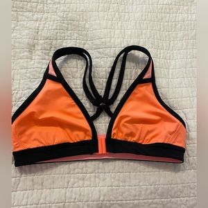 Lululemon bathing suit top. Front clasp. Size 6. Neon Orange/black. No damages.